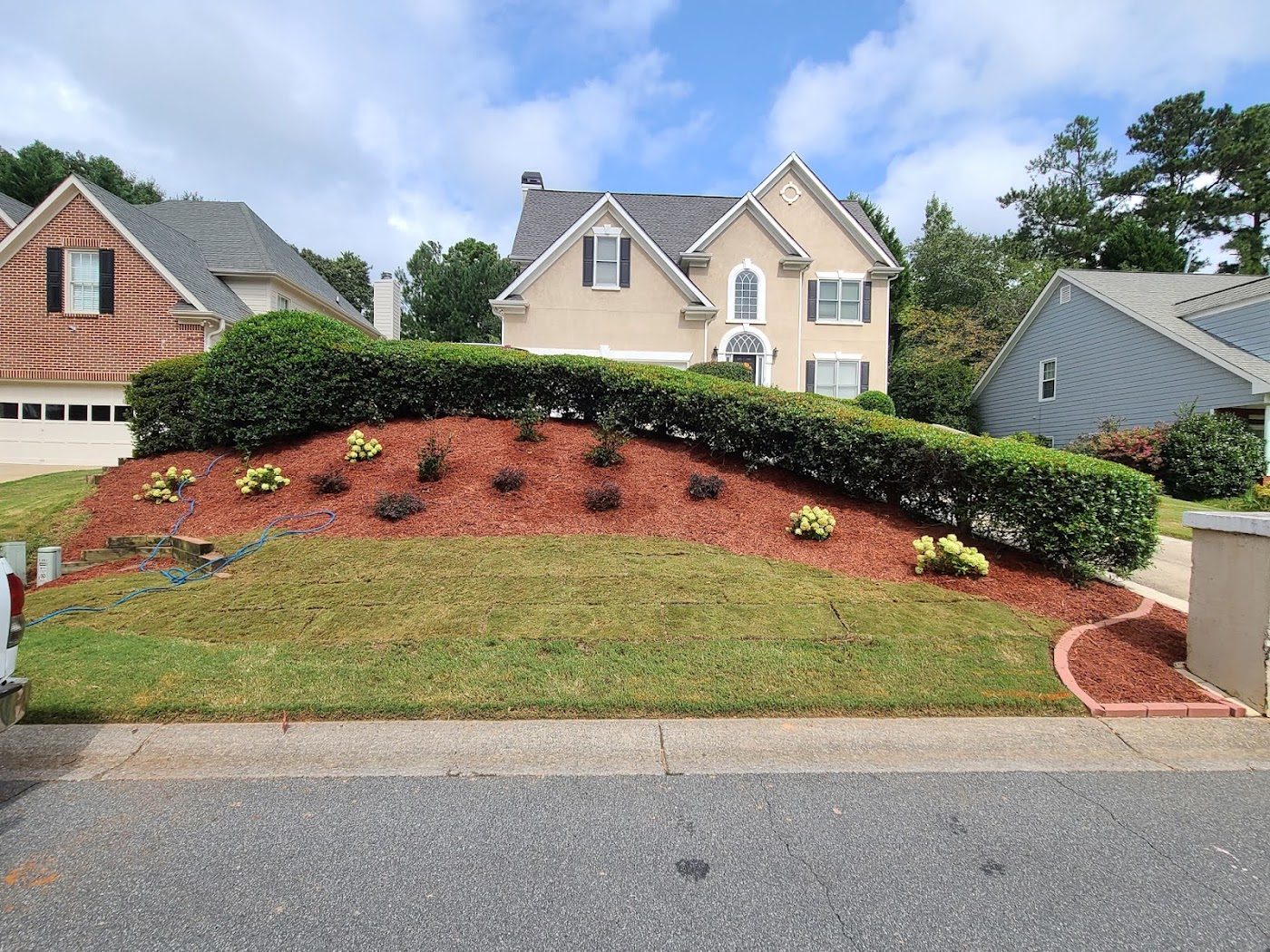 New front-yard bed with red mulch
